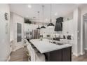 Modern kitchen with stainless steel appliances, a large island with seating, white cabinets, and a pantry at 2605 S Quaintance St, Gilbert, AZ 85295