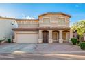 Inviting home with an arched entryway, two-car garage, and a tiled roof at 2652 E Riviera Dr, Chandler, AZ 85249