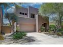 Contemporary two-story home featuring desert landscaping, attached garage, and neutral color palette at 27892 N 108Th Way, Scottsdale, AZ 85262