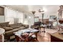 Open-concept living room with a fireplace and natural light with a view of the backyard at 2944 W Northern Ave, Phoenix, AZ 85051