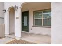 Welcoming front porch with arched columns and a green door at 4063 E Amoroso Dr, Gilbert, AZ 85296