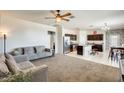 Bright and airy living room featuring a large open space connected to the kitchen and dining area at 4080 N 309Th Cir, Buckeye, AZ 85396