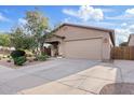 Charming single-story home featuring a well-maintained lawn, desert landscaping, and a two-car garage at 41138 N Soap Berry St, Queen Creek, AZ 85140