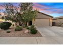 Charming single-story home featuring a well-maintained lawn, desert landscaping, and a two-car garage at 41138 N Soap Berry St, Queen Creek, AZ 85140