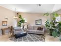 Bright living room featuring neutral walls, tile flooring, and large windows that fill the space with natural light at 420 N Leoma Ln, Chandler, AZ 85225