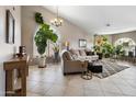Bright living room featuring neutral walls, tile flooring, and large windows that fill the space with natural light at 420 N Leoma Ln, Chandler, AZ 85225