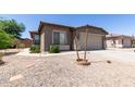 Well-kept home with a two-car garage, low-maintenance yard, and a neat, attractive appearance at 42347 W Bunker Dr, Maricopa, AZ 85138