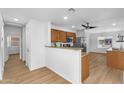 Cozy kitchen with wooden cabinets, stainless steel appliances, breakfast bar, and adjacent dining area at 43787 W Colby Dr, Maricopa, AZ 85138