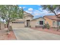 Charming two-story home featuring a three-car garage and desert landscaping at 44890 W Desert Garden Rd, Maricopa, AZ 85139