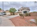 Charming two-story home featuring a three-car garage and desert landscaping at 44890 W Desert Garden Rd, Maricopa, AZ 85139