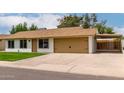 Charming single-story home with a manicured lawn and a light colored roof at 510 N Entrada St, Chandler, AZ 85226