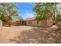 Spacious backyard featuring a covered patio and desert landscaping, perfect for outdoor enjoyment at 7019 S 19Th Pl, Phoenix, AZ 85042