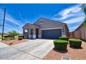 Well-manicured lawn and tidy landscaping complement this cozy single-level home with an attached garage at 7751 W Miami St, Phoenix, AZ 85043