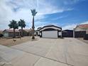 Single-story home featuring tile roof, desert landscaping, driveway, and an attached garage at 9231 W Grovers Ave, Peoria, AZ 85382