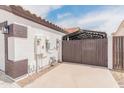 A practical side yard featuring a covered storage area, perfect for utility and function at 9231 W Grovers Ave, Peoria, AZ 85382