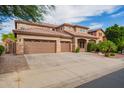 Beautiful home with a three car garage, well-manicured lawn and attractive desert landscaping at 9622 S 46Th Ln, Laveen, AZ 85339
