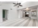 Bright and airy living room with vaulted ceilings and a ceiling fan, carpet and an open view into the kitchen at 9990 N Scottsdale Rd # 2029, Paradise Valley, AZ 85253