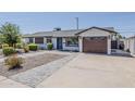 Well-maintained home exterior features a one-car garage, modern driveway, and low maintenance desert landscaping at 1003 E Marigold Ln, Tempe, AZ 85288
