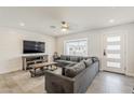 Inviting living room with a large sectional couch, modern flooring, and ample natural light at 1003 E Marigold Ln, Tempe, AZ 85288