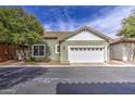 Charming home featuring a two-car garage, well-manicured lawn, and appealing curb appeal at 1143 S Annie Ln, Gilbert, AZ 85296