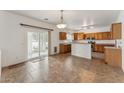 Eat-in kitchen features tiled floors, wood cabinetry, and a sliding door to the backyard at 120 N Pottebaum Rd, Casa Grande, AZ 85122