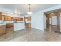 Spacious kitchen with tiled floors, plenty of wooden cabinets, and a breakfast bar at 120 N Pottebaum Rd, Casa Grande, AZ 85122