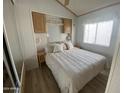 Cozy bedroom featuring a queen-sized bed, built-in cabinets, and soft natural light from the window at 1226 S Seneca Dr, Apache Junction, AZ 85119