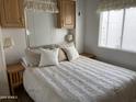 Comfortable bedroom with neutral tones, a large bed, and matching nightstands for a relaxing retreat at 1226 S Seneca Dr, Apache Junction, AZ 85119