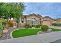 Attractive single-story home displaying manicured lawn, desert landscaping and an attached garage at 13353 W Gloria Ln, Peoria, AZ 85383