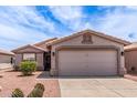 Single story home featuring desert landscaping, and a two car garage at 1395 E Runaway Bay Dr, Chandler, AZ 85249