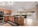 Open concept kitchen with granite countertops, stainless steel appliances, and a cozy breakfast bar at 1395 E Runaway Bay Dr, Chandler, AZ 85249