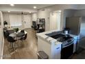 Living area with a dining table, sofa, and adjacent kitchen featuring modern appliances at 1449 E Highland Ave # 25, Phoenix, AZ 85014