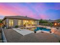 Enjoy this backyard oasis featuring a sparkling pool and spa, perfect for relaxation and entertaining, surrounded by desert landscape at 14523 E Charter Oak Dr, Scottsdale, AZ 85259