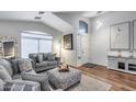 Inviting living room with vaulted ceiling, wood floors and neutral decor provides a relaxing atmosphere at 15743 N 165Th Ln, Surprise, AZ 85388