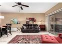 Well lit living room features a leather sofa, dining area and a large area rug at 16626 E Westby Dr # 108, Fountain Hills, AZ 85268