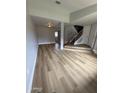 Spacious living room featuring modern flooring and seamless transition to the staircase at 170 E Guadalupe Rd # 173, Gilbert, AZ 85234