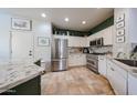 Modern kitchen with stainless steel appliances, granite countertops, and custom cabinetry, perfect for culinary enthusiasts at 18550 W Mcneil St, Goodyear, AZ 85338