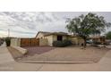 The side yard features privacy wall and low-maintenance desert landscaping at 18550 W Mcneil St, Goodyear, AZ 85338