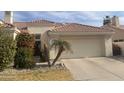 Charming single-story home featuring a two-car garage and drought-resistant landscaping at 2127 W Peninsula Cir, Chandler, AZ 85248