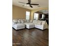 Spacious living room featuring hardwood floors and a large sectional couch with throw pillows at 21544 W Watkins St, Buckeye, AZ 85326