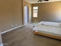 Main bedroom features natural light and an ensuite bathroom with neutral paint at 21544 W Watkins St, Buckeye, AZ 85326