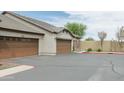 View of a beige home with multi-car garage and neutral landscaping, showcasing its spacious driveway at 2725 E Mine Creek Rd # 1208, Phoenix, AZ 85024
