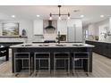 Well-equipped kitchen with a central island, modern light fixtures, and bar stool seating at 2802 E Mercer Ln, Phoenix, AZ 85028