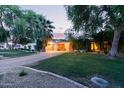 View of home featuring a lush green lawn, a brick driveway and mature trees at 301 W Royal Palm Rd, Phoenix, AZ 85021
