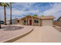 Attractive single-story house with desert landscaping, concrete driveway, and an attached garage at 3620 E Ludlow Dr, Phoenix, AZ 85032