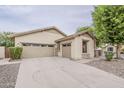 Single-story home featuring a two-car garage, desert landscaping, and a neutral color scheme at 4067 S White Dr, Chandler, AZ 85249