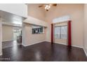 Bright living room featuring wood floors, high ceilings, and large windows at 4114 E Muirwood Dr, Phoenix, AZ 85048