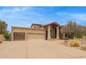 Wide driveway leading to a house with a three-car garage and well-kept landscaping at 4922 W Fallen Leaf Ln, Glendale, AZ 85310