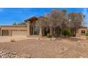 Beautiful desert home with drought-resistant landscaping and a three-car garage at 4922 W Fallen Leaf Ln, Glendale, AZ 85310