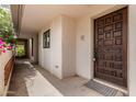 Inviting entrance featuring a dark wooden door and walkway to the home at 5200 S Lakeshore Dr # 206, Tempe, AZ 85283